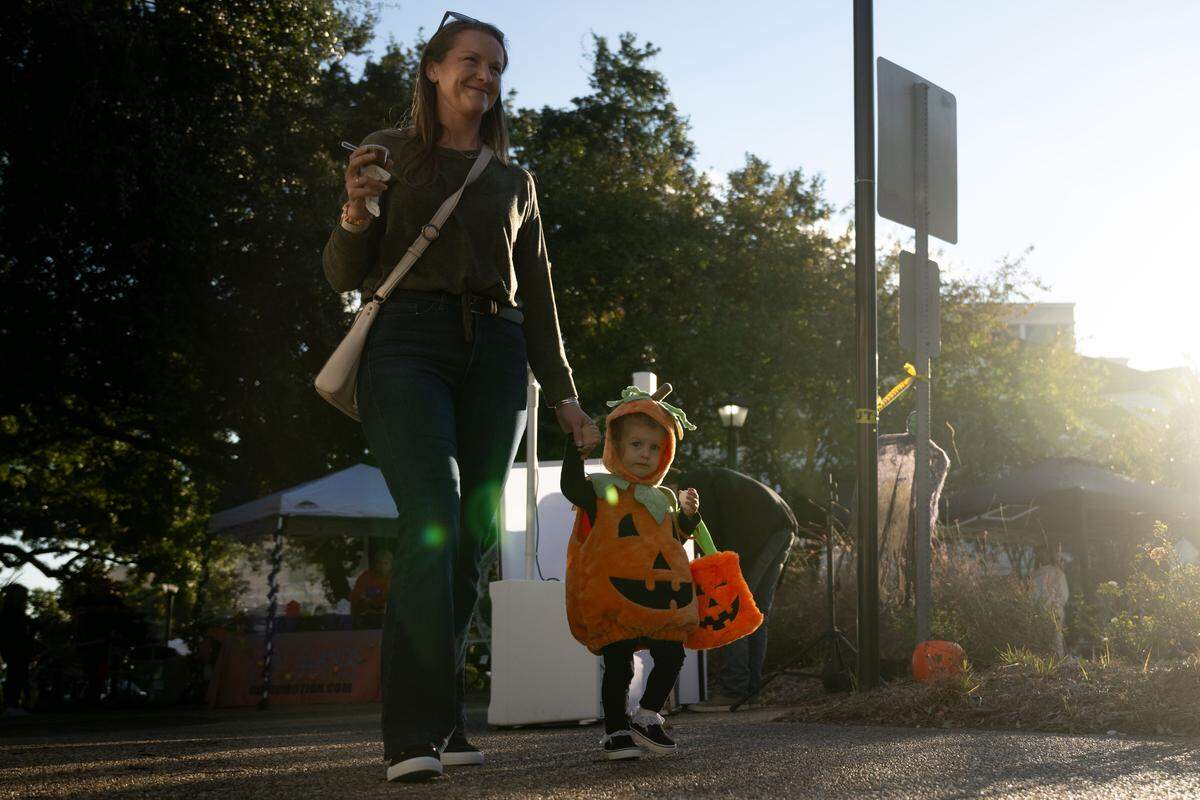 Lily Petzy, right, and Corie Petzy, left, walk down Rue Magnolia during Boo On The Rue in Biloxi on Thursday, October 30, 2025.