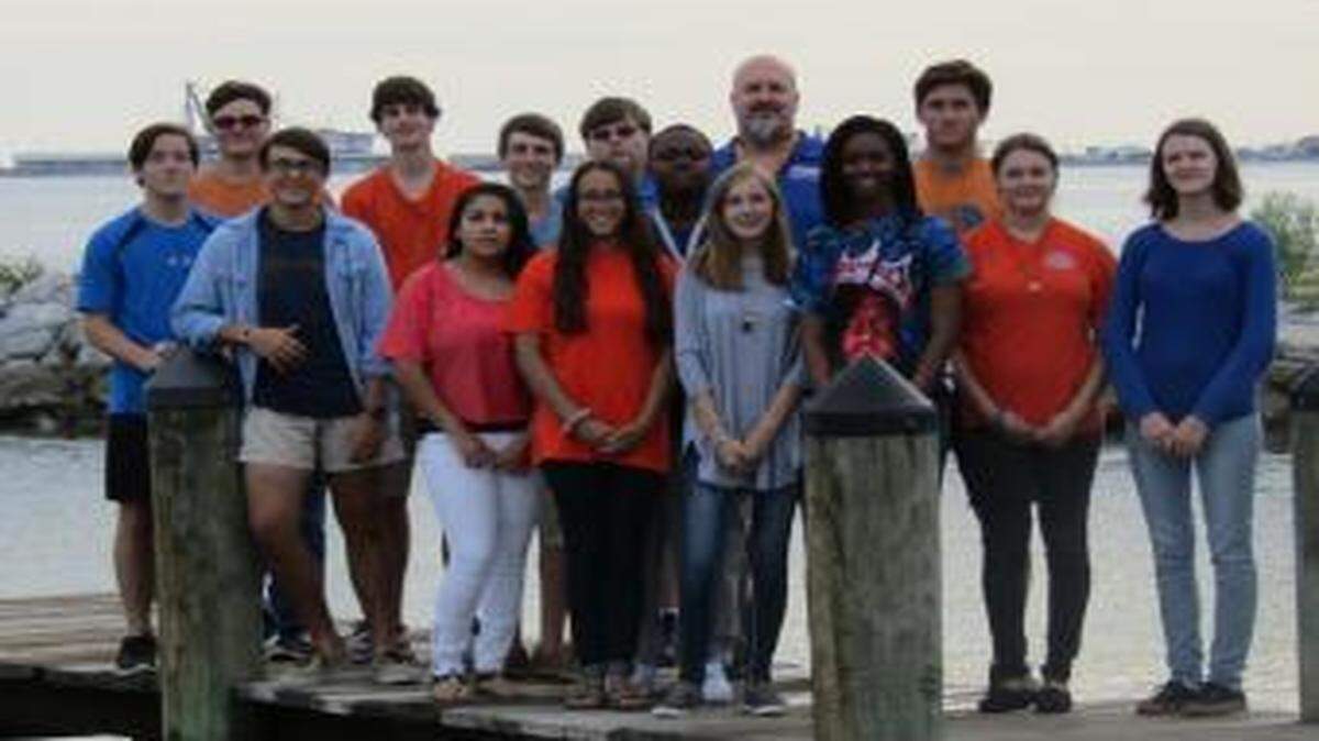 This group of 14 Gulfport High School students was awarded a grant to build a hydraulic lift to help those with disabilities board boats.