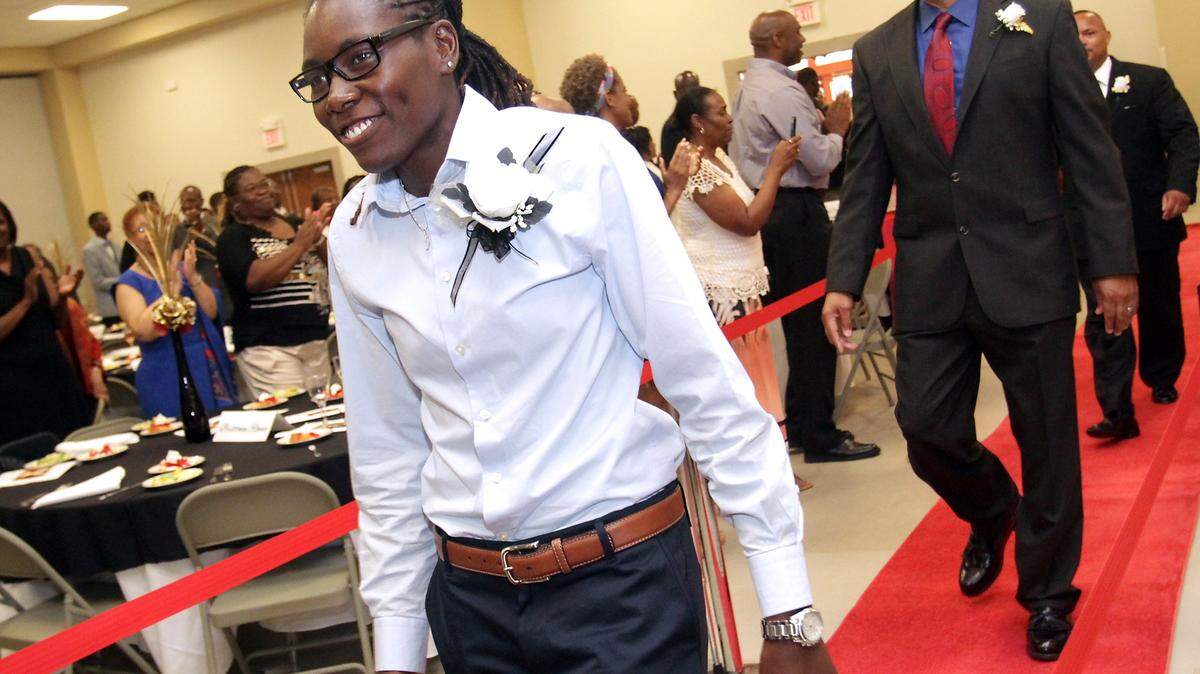AMANDA McCOY/SUN HERALD/2014 
 Olympic gold medalist Brittney Reese walks down the red carpet with other Gulfport Sports Hall of Fame inductees. She won the long jump at the U.S. Indoor Track and Field Championships in Portland, Ore., over the weekend.