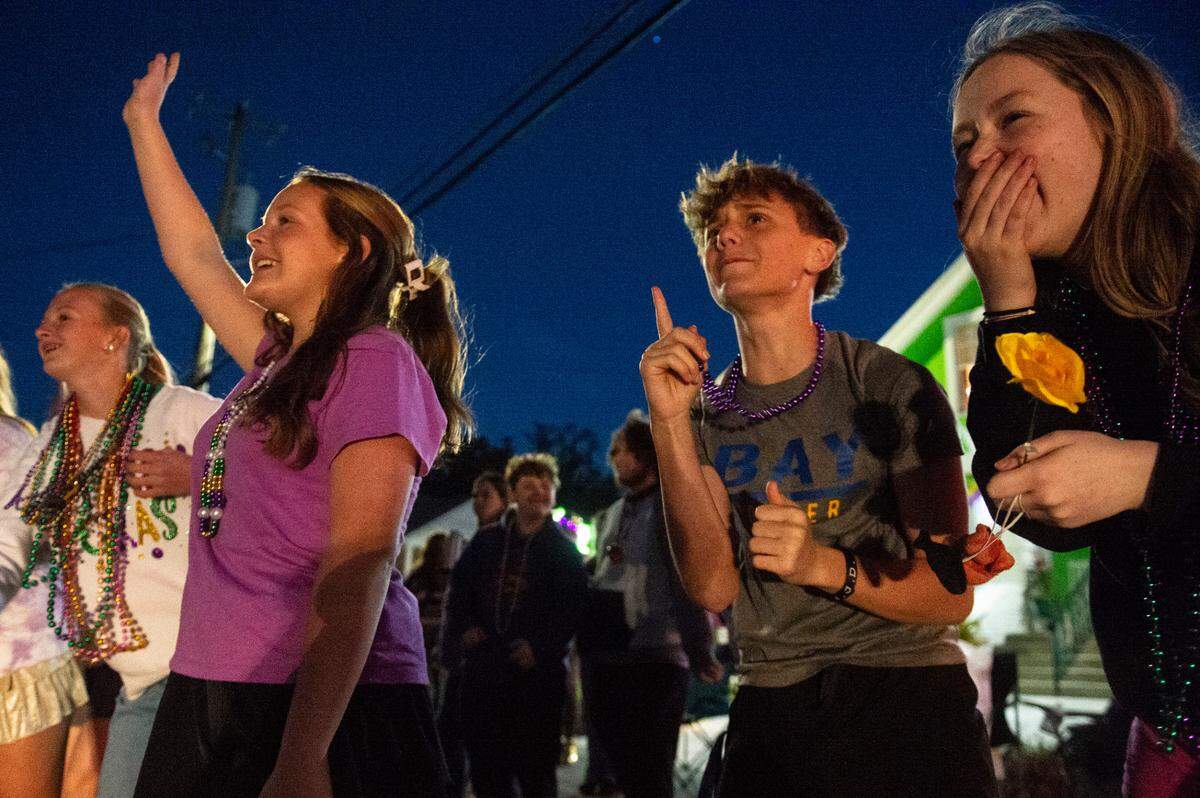Kids cheer for beads during Mystic Krewe of the Seahorse’s Lundi Gras parade in Bay St. Louis on Monday, March 3, 2025.