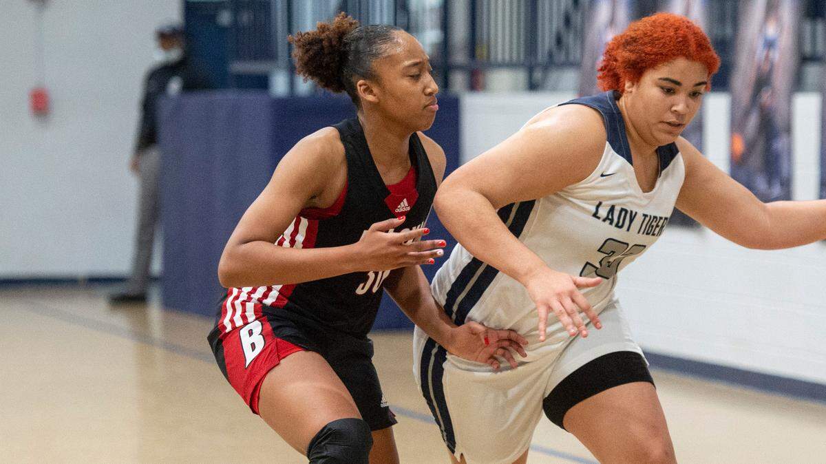 Moss Point’s Morgan Sullivan dribbles the ball away from Biloxi’s Shaneal Corpuz during a game against Biloxi at Moss Point High School in Moss Point on Tuesday, Dec. 21, 2021.