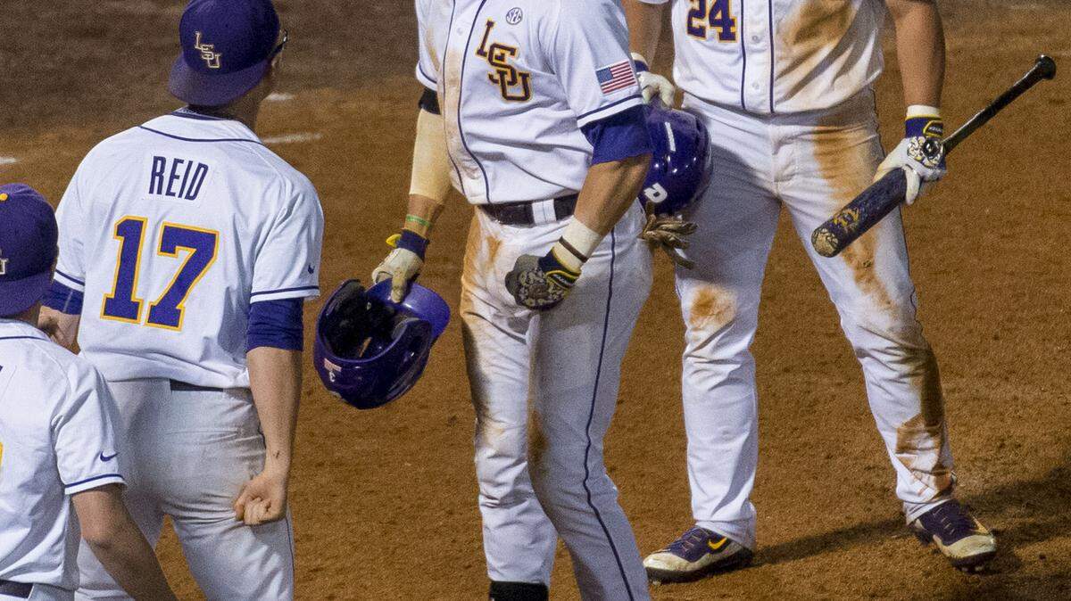 LSU's Greg Deichmann, middle, celebrates with teammates after tying the score in the bottom of the ninth inning on a solo home run against Tennessee during a college baseball game in the Southeastern Conference tournament Tuesday, May 24, 2016, in Birmingham, Ala. (Vasha Hunt/AL.com via AP)