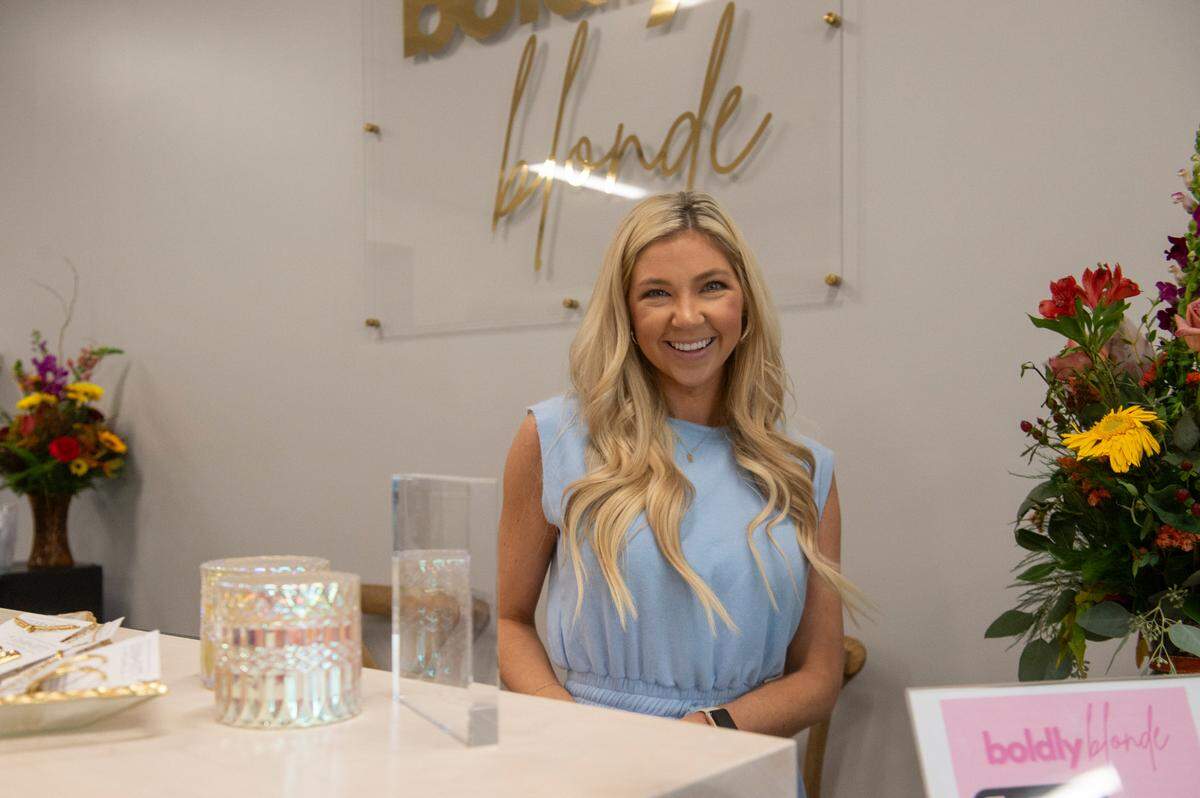 Boldly Blonde boutique owner Carson Odom poses for a photo at her new business in Ocean Springs.