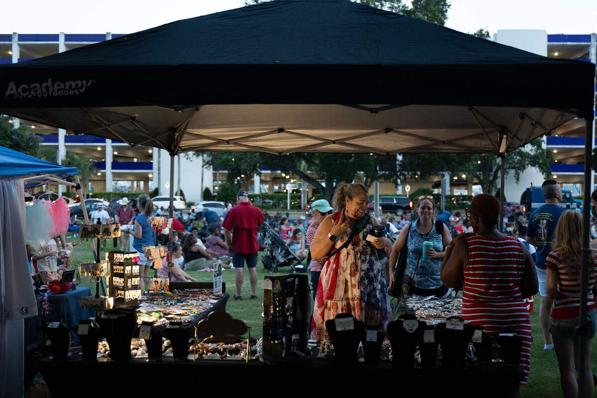 Attendees browse for jewelry at a vendor stand during the Fourth of July show at the Biloxi Town Green on Saturday, July 4, 2026.