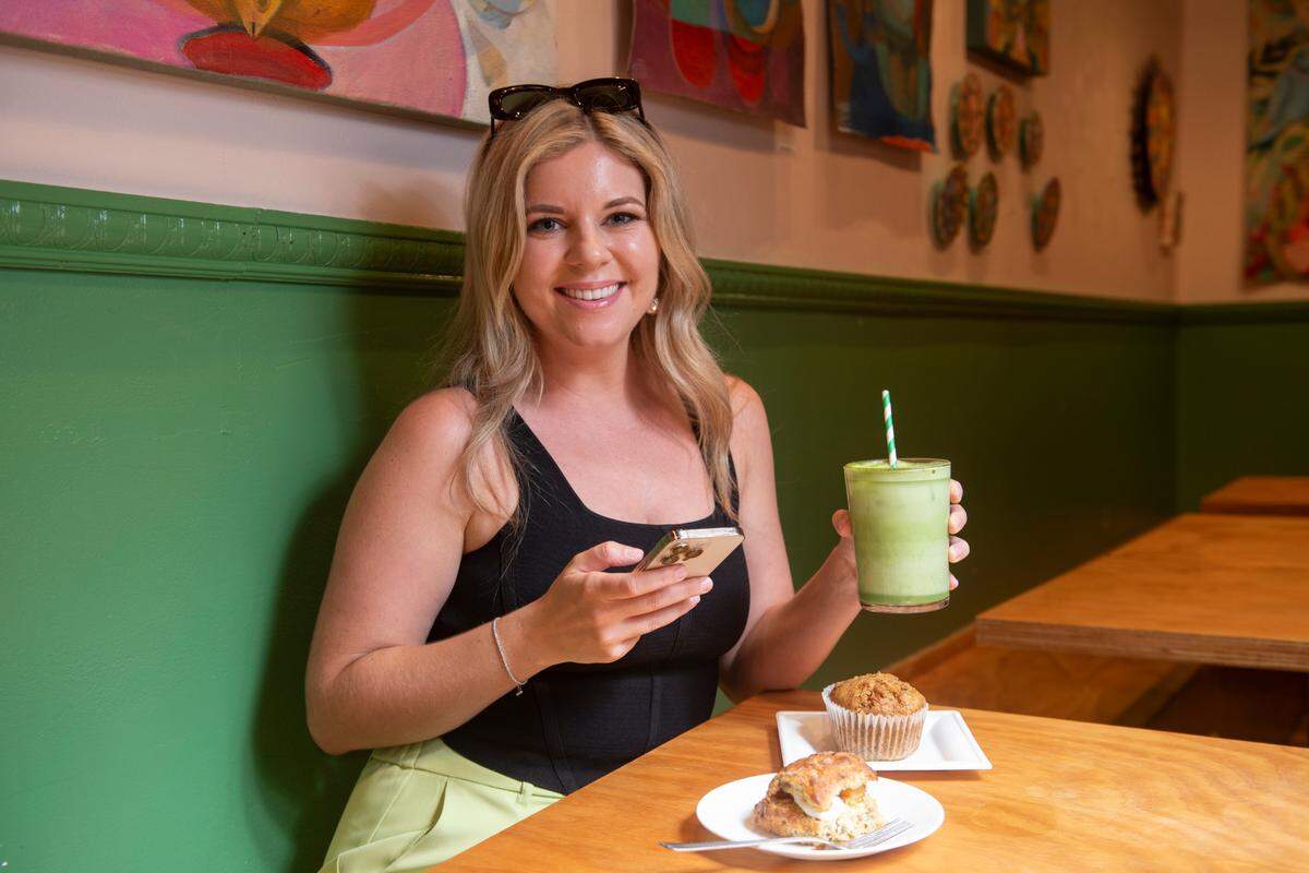 Alexa Harrison, who owns Gather Gulf Coast, a popular Instagram account and marketing company promoting local Mississippi Coast businesses, at Greenhouse Cafe in Biloxi on Friday, July 26, 2024.