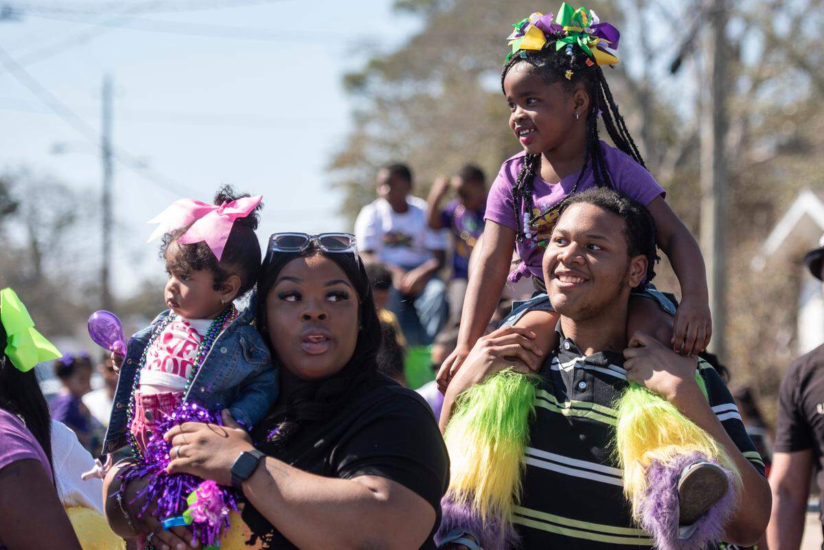 Parade attendees try to catch beads during the Jackson County Carnival Association Mardi Gras parade in Pascagoula on Saturday, March 1, 2025.