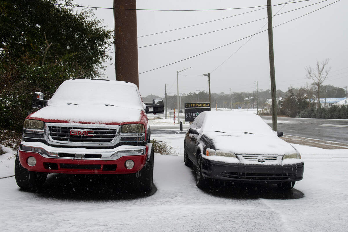 Snow accumulates on cars in Ocean Springs on Tuesday, Jan. 21, 2025.