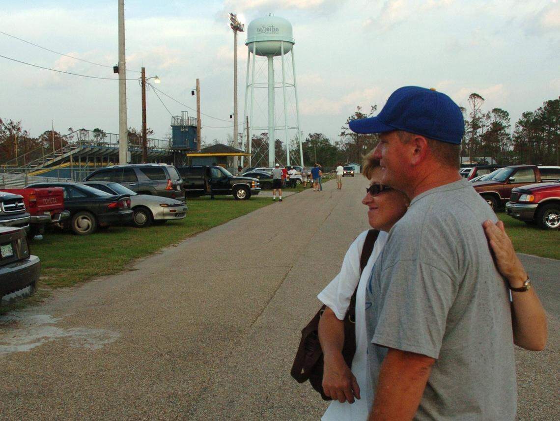 Suzy Gilmore gives Gene Moran a hug outside McCullough stadium in Bay St. Louis before the first Bay St. Louis game after Hurricane Katrina. “The community came together to make this (game) happen,” said Moran, whose son, Kyle, was on the team.