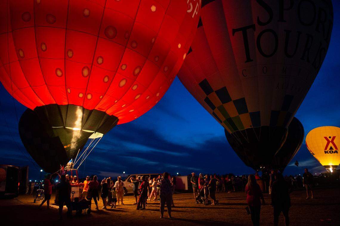 Hot air balloon pilots fire their burners to light up their balloons during the Gulf Coast Hot Air Balloon Festival at OWA in Foley, Alabama on Thursday, May 4, 2023.