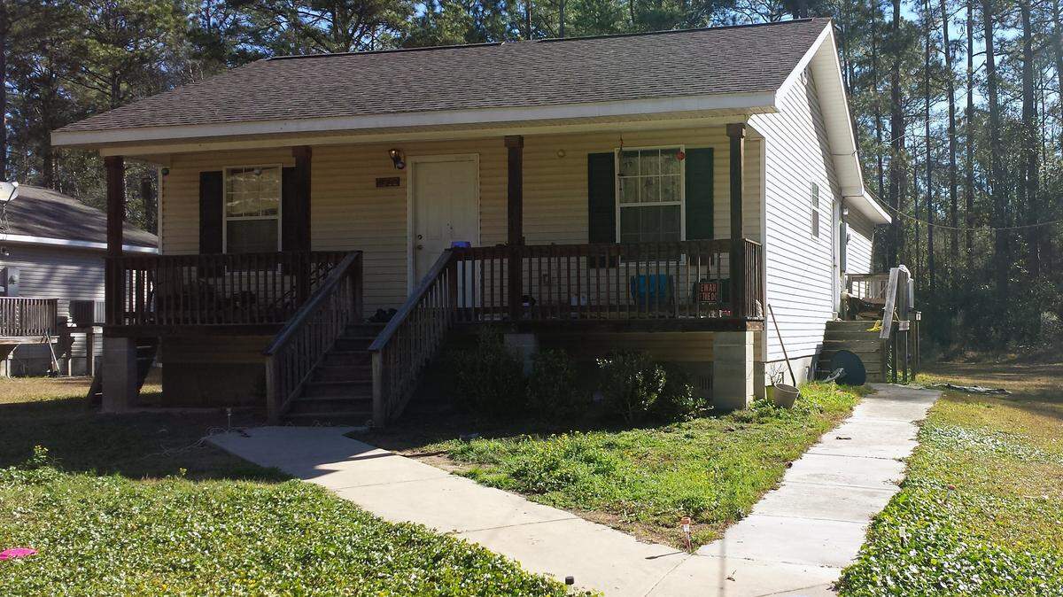 KAREN NELSON/SUN HERALD 
 This house at 7312 Home of Grace Drive still had crime scene tape on the steps leading up to the right side of the house on Wednesday morning. Neighbors said an incident last night at the house involved multiple shots from someone in the house and lasted two hours.