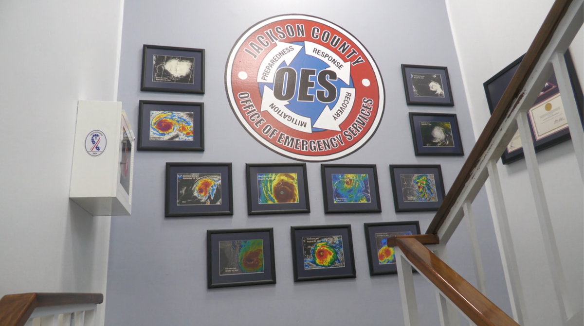 The Jackson County Office of Emergency Services displays satellite images of past hurricanes on its wall.