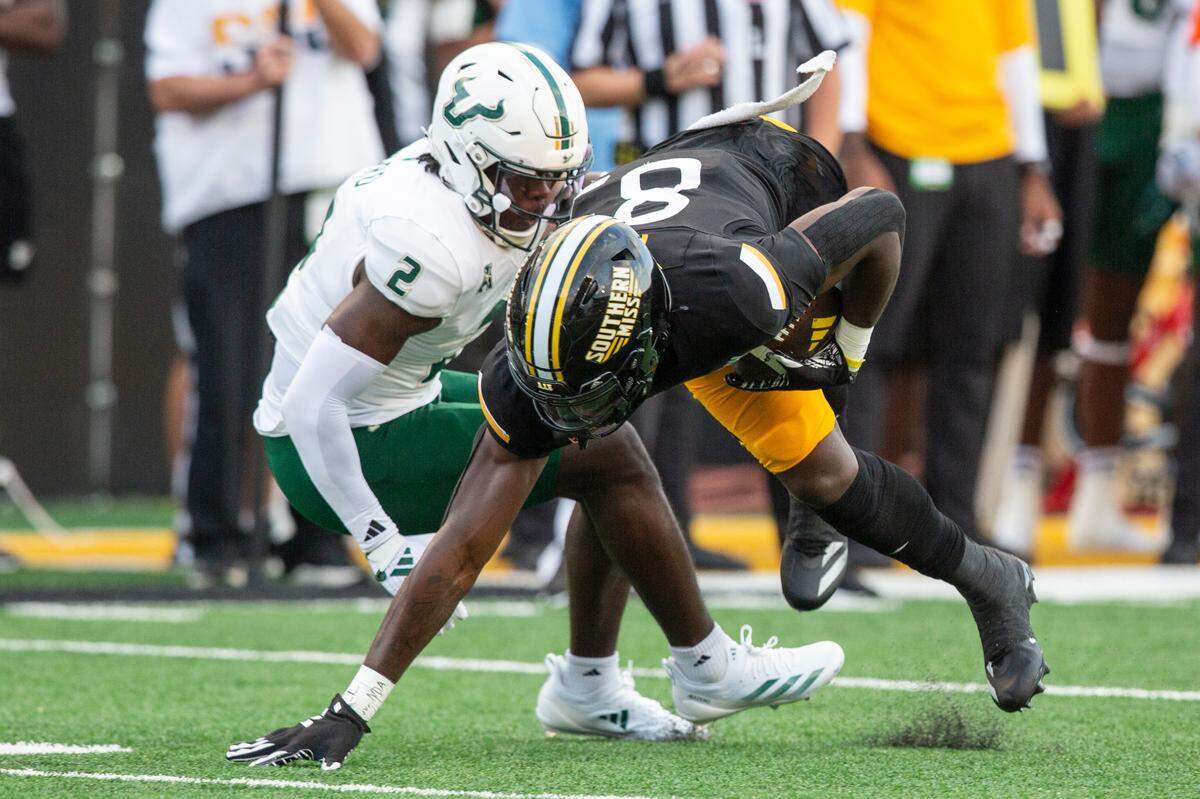 Southern Miss Golden Eagles tight end Kyirin Heath (85) gets tackled by South Florida Bulls defensive back Tavin Ward (2) during a game between Southern Miss and South Florida at M.M. Roberts Stadium in Hattiesburg on Saturday, Sept. 14, 2024.