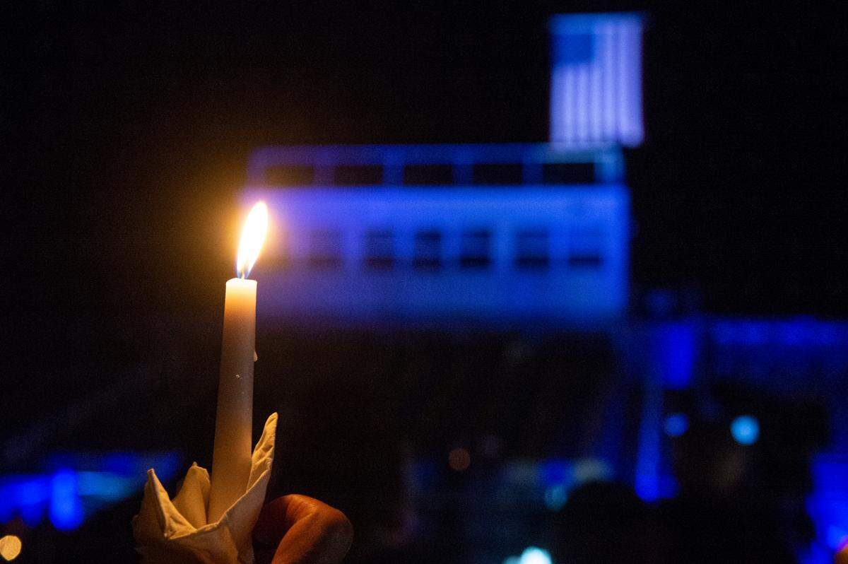 Members of the Bay St. Louis light candles during a candlelit vigil for Bay St. Louis Sgt. Steven Robin and officer Branden Estorffe at Tiger Stadium in Bay St. Louis on Thursday, Dec. 15, 2022. Robin and Estorffe were killed on Wednesday when a woman shot both of them.