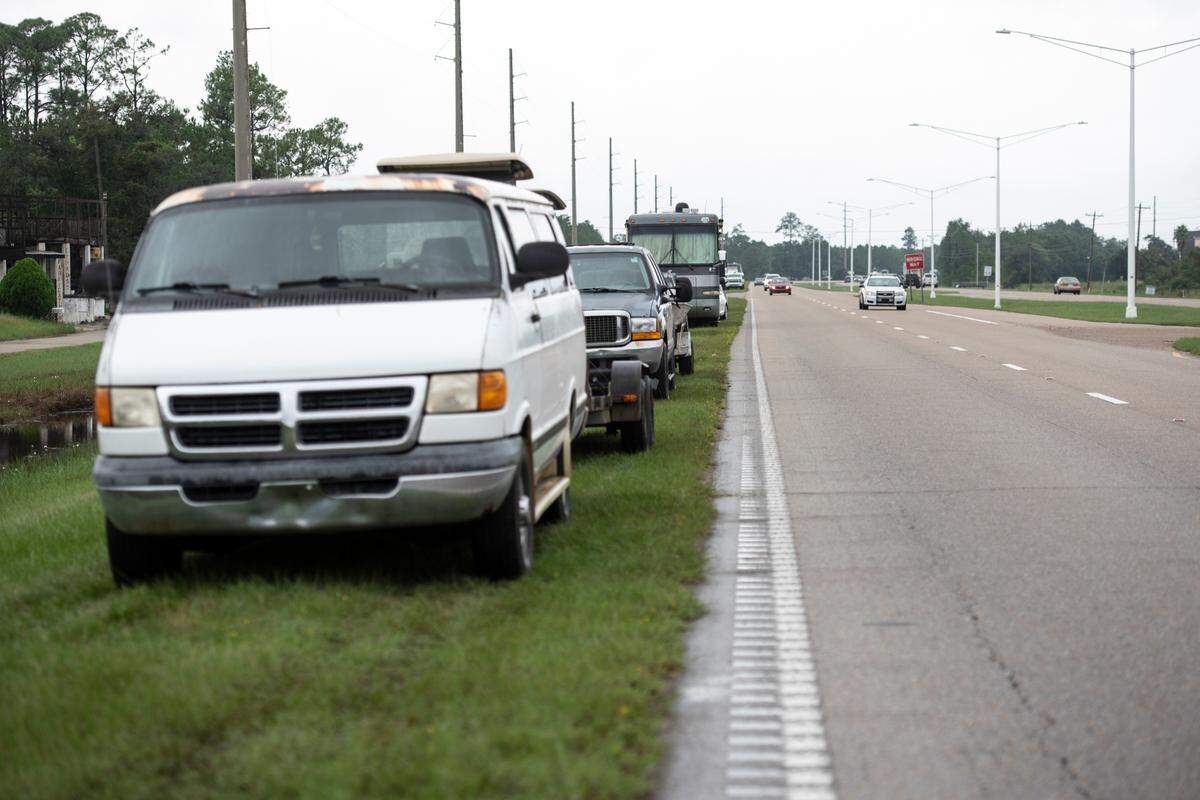 Vehicles are parked on the high ground on the side of Highway 603 in Waveland on Tuesday, Sept. 10, 2024, ahead of Hurricane Francine.