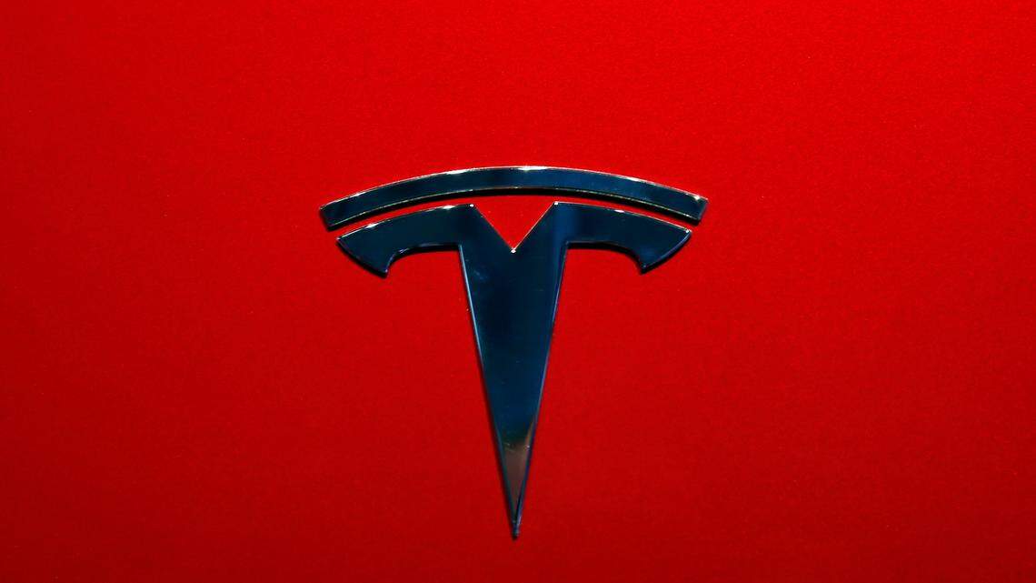 FILE- This Oct. 3, 2018, file photo shows a Tesla logo at an auto show in Paris. After refusing a request from U.S. safety regulators, Tesla has now agreed to recall about 135,000 vehicles because the large touch screens can go dark. The electric car company says it will recall certain 2012 through 2018 Model S sedans and 2016 through 2018 Model X SUVs to fix the problem. (AP Photo/Christophe Ena, File)