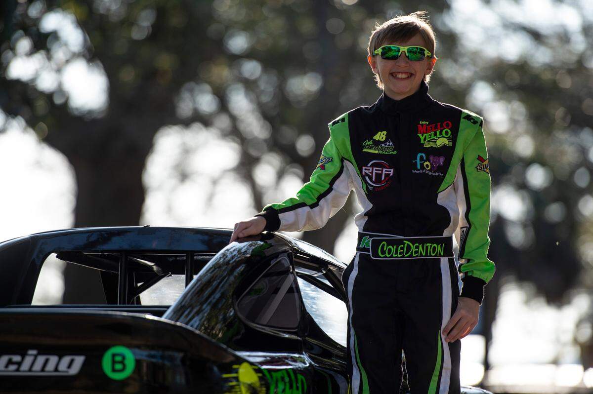 Nicolas “Cole” Denton, 11, also known as “Cole Trickle”, after the iconic Days of Thunder movie character, poses next to his Bandolero racecar at Pascagoula Beach Park in Pascagoula on Thursday, March 10, 2022.