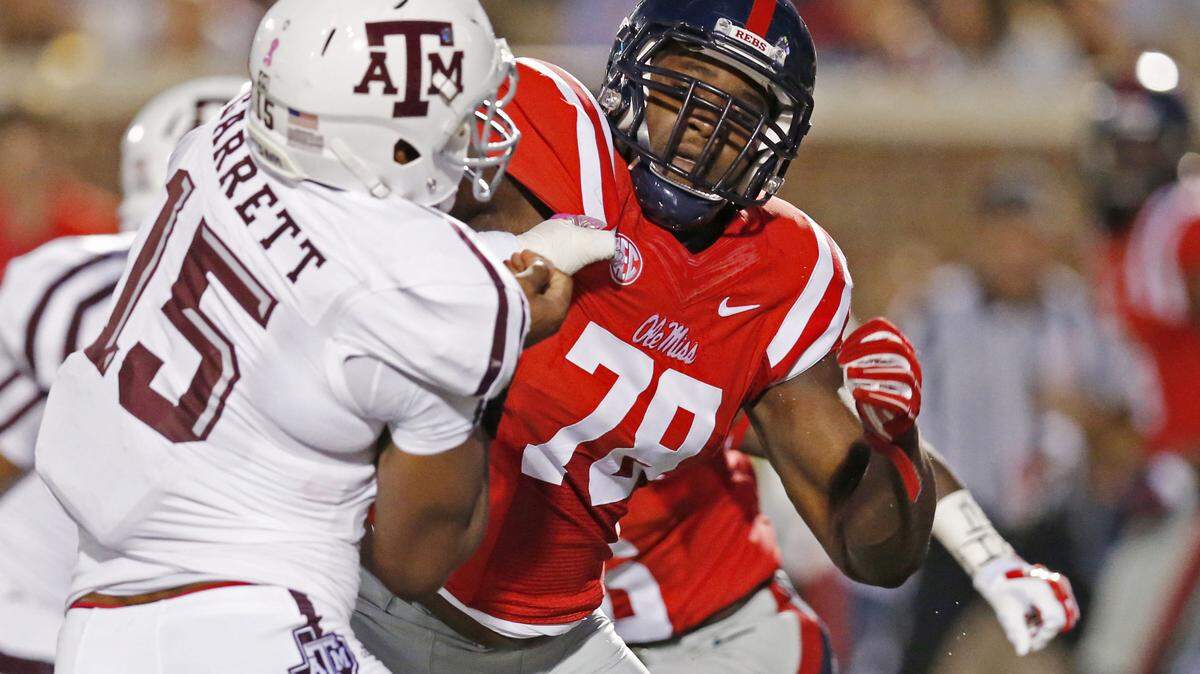 FILE - In this Oct. 24, 2015, file photo, Texas A&M defensive lineman Myles Garrett (15) is blocked by Mississippi offensive lineman Laremy Tunsil (78) during the first half of their NCAA college football game in Oxford, Miss. Tunsil is one of the top offensive players available in the NFL Draft, which starts April 28 in Chicago. (AP Photo/Rogelio V. Solis, File)