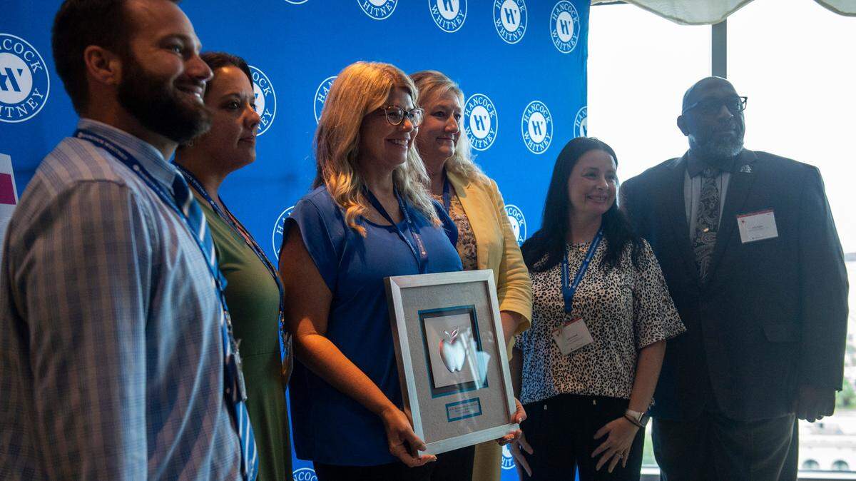 Karen Jean Boutwell, center, poses for a photo with her coworkers after winning a Leo W. Seal grant during the Leo W. Seal awards luncheon at the Great Southern Club in Gulfport on Friday, Aug. 26, 2022.