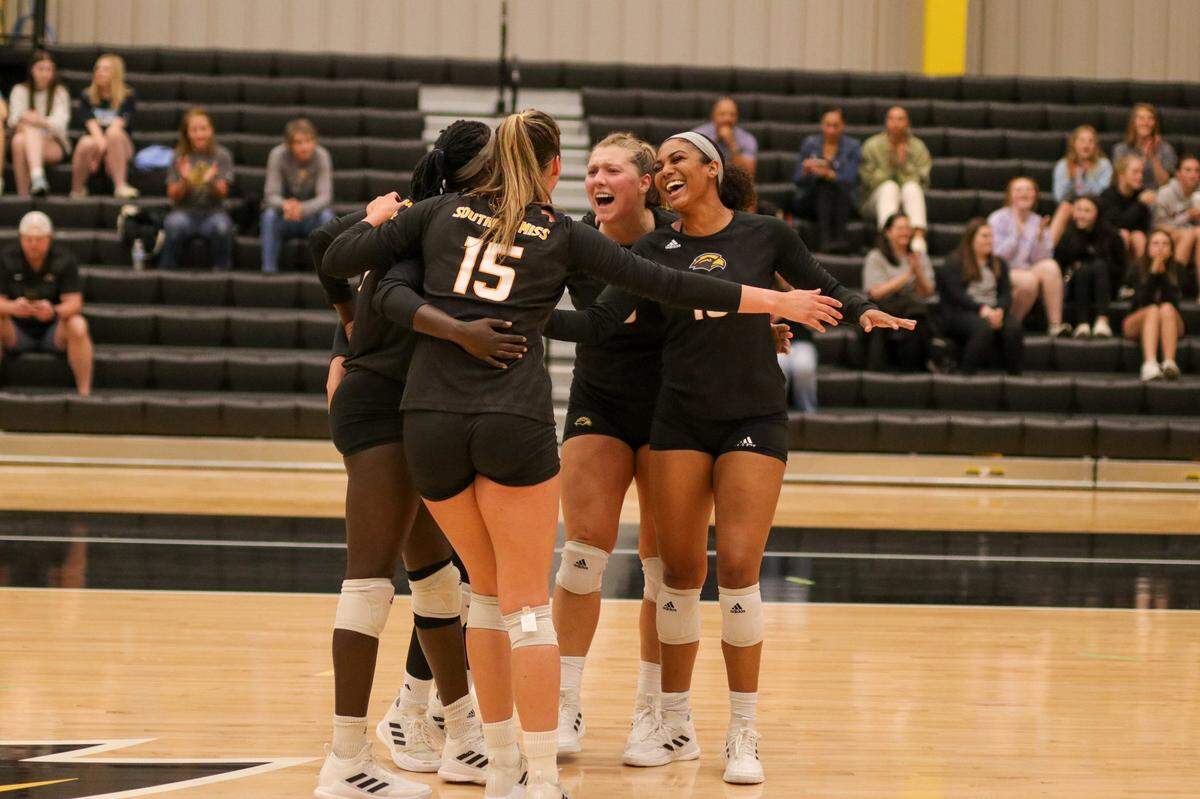 Southern Miss volleyball celebrates during the first exhibition of the Jenny Hazelwood era