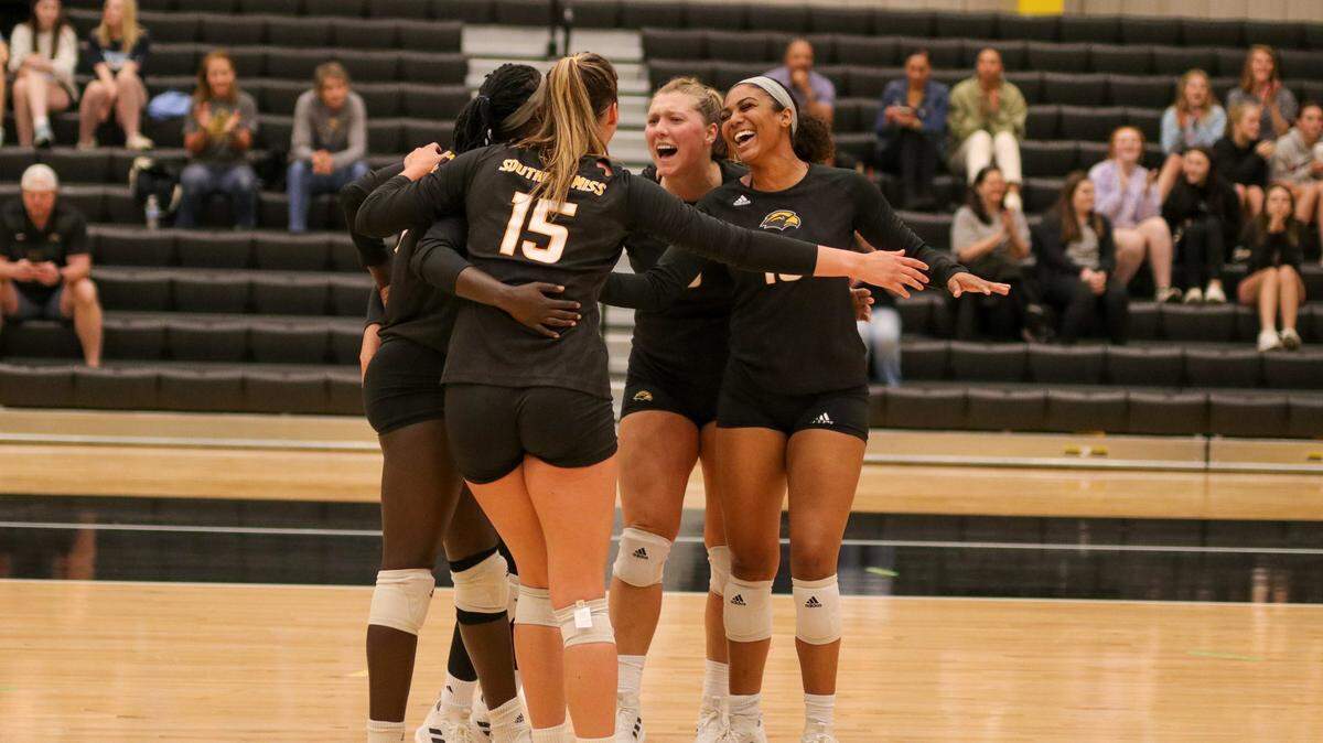 Southern Miss volleyball celebrates during the first exhibition of the Jenny Hazelwood era