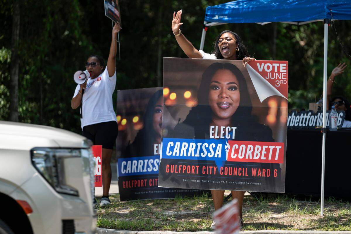 Carrissa Corbett campaigns outside Orange Grove Community Center in Gulfport on June 3.