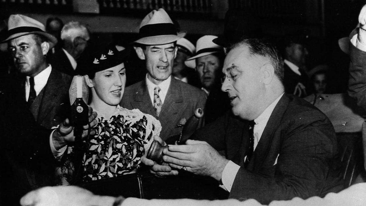 In 1937 during a presidential motorcade on the Mississippi Gulf Coast, June Braun, daughter of the then mayor of Biloxi, presents President Franklin D. Roosevelt with a gavel made from cedar wood harvested at Beauvoir.