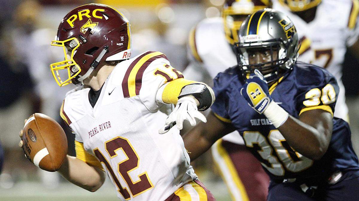 TIM ISBELL/SUN HERALD 
 PRCC quarterback Matt Williams scrambles away from the pressure of MGCCC's Joe Green. Williams will see plenty of action against East Central on Thursday.