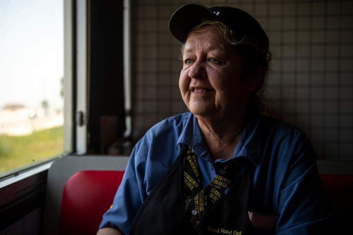 Vicki Dean, a server at Waffle House, poses for a portrait at Waffle House in Gulfport on Wednesday, July 28, 2021. Dean has had to take the bus to work after her car was damaged, according to Dean, by Oscar Renda.