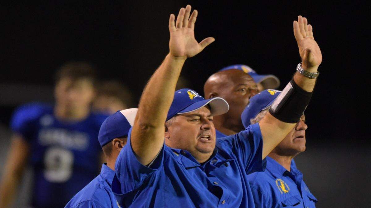 GLENN ANDREWS/SPECIAL TO THE SUN HERALD 
 Resurrection Catholic head coach Scott Sisson signals his players as they take on Pass Christian on Aug. 28 at War Memorial Stadium in Pascagoula.