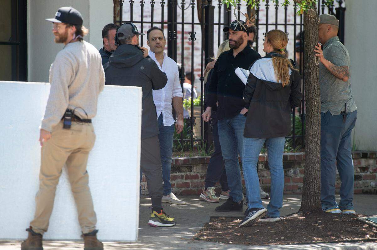 Actor John Travolta, center right, on the set of Cash Out 3 during filming on Washington Avenue in Ocean Springs on Tuesday, April 8, 2025.