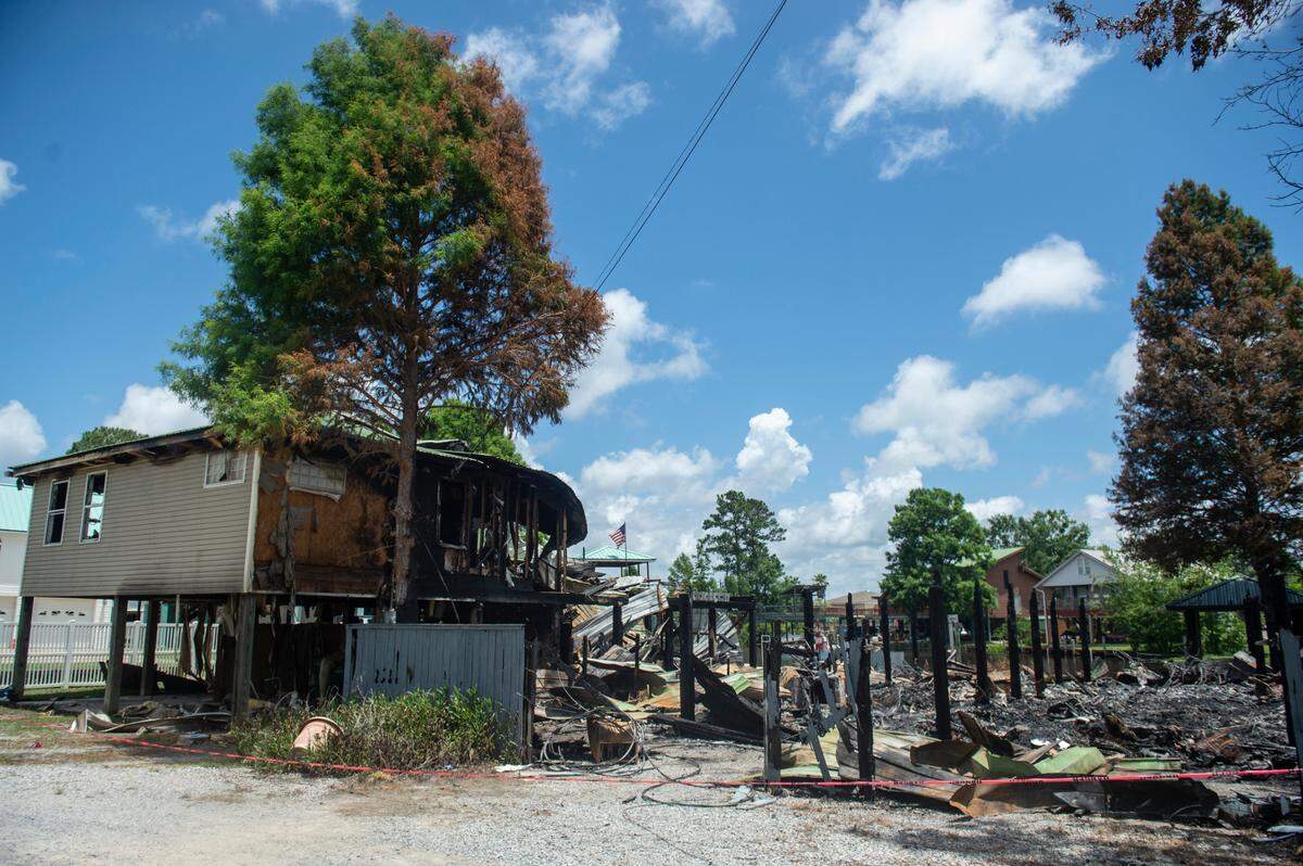 Half of one home remains on a section of Highway 603 in the Kiln on Tuesday, May 31, 2022 after a fire tore through two houses Saturday night, killing two.