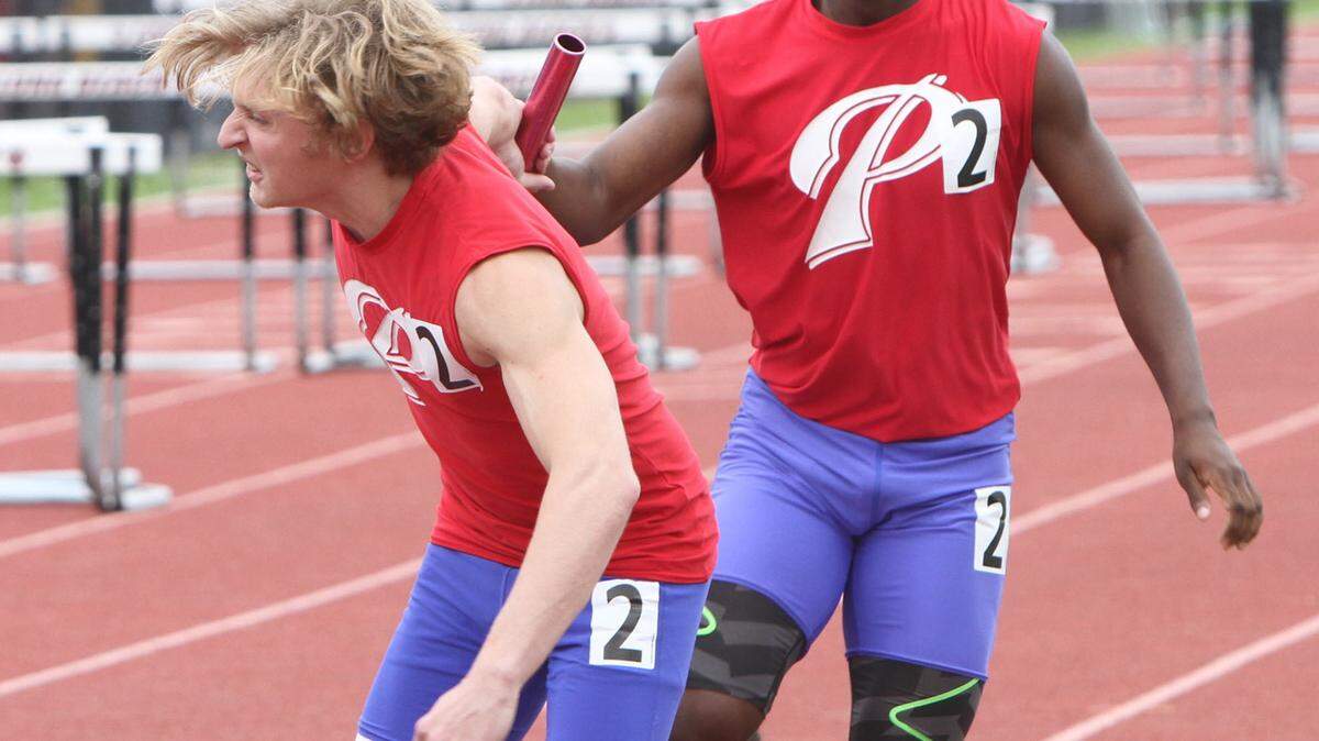 JOHN FITZHUGH/SUN HERALD 
 Pascagoula's Ramon Richardson hands off to Samuel King in the 5A 4 X 800 relay at the South State track meet at Lance Lumpkin Stadium in Long Beach on Saturday April 30, 2016. Pascagoula finished third.