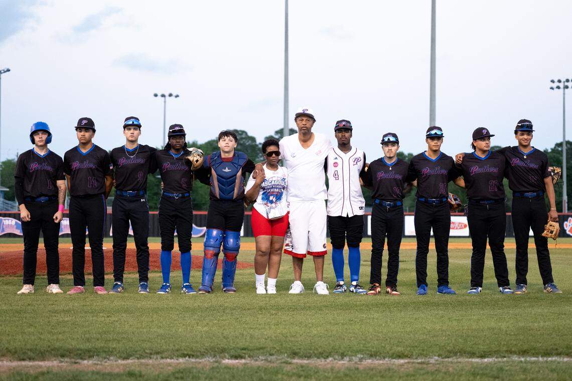 Pascagoula players stand with Carlos and Erika Knowles before Thursday’s game.