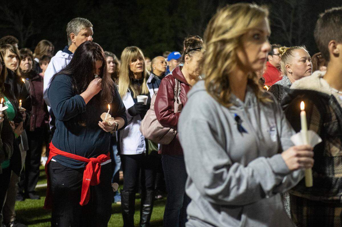 Members of the Bay St. Louis community stand with candles during a candlelit vigil for Bay St. Louis Sgt. Steven Robin and officer Branden Estorffe at Tiger Stadium in Bay St. Louis on Thursday, Dec. 15, 2022.