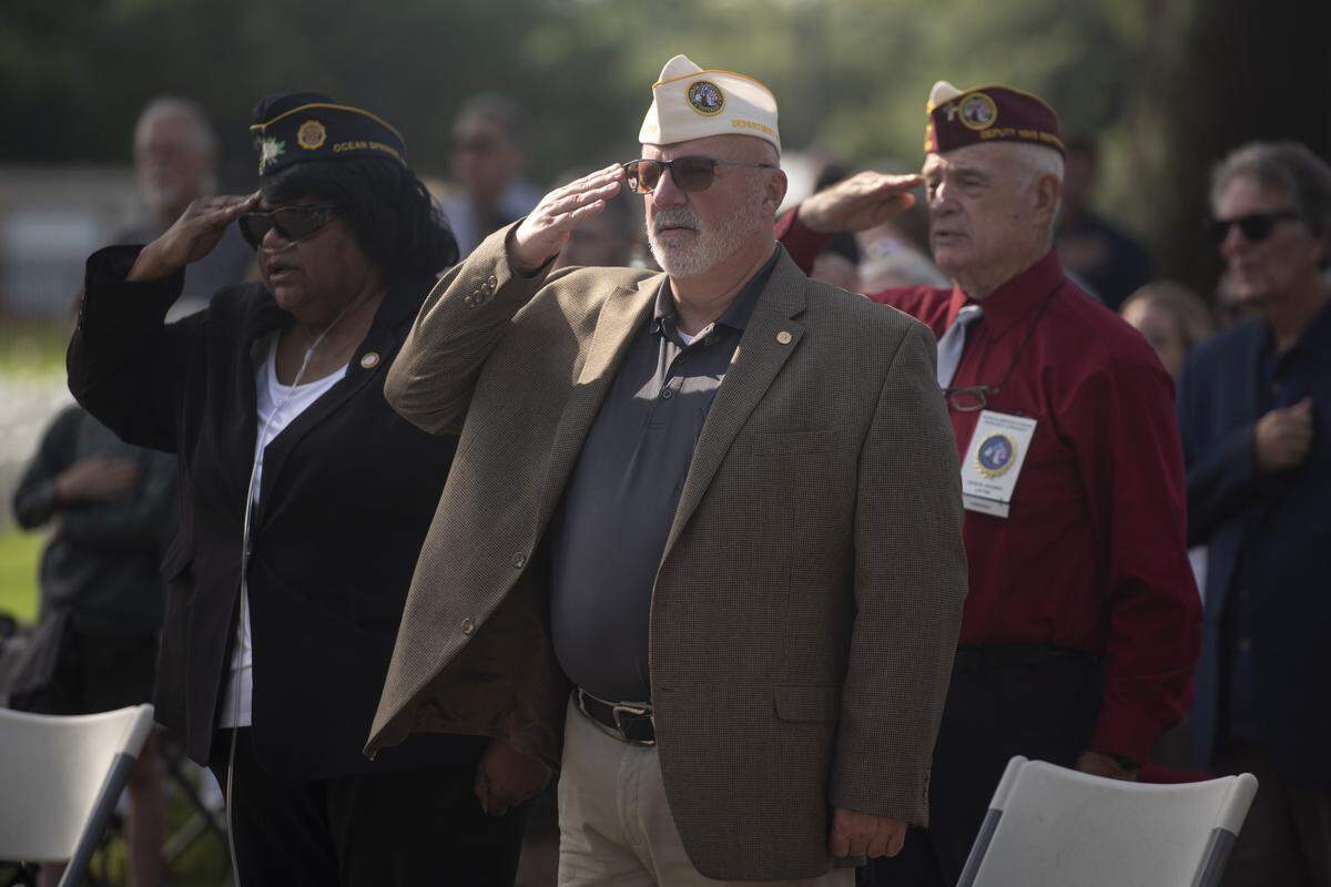 Veterans salute the flag during a Memorial Day ceremony at Biloxi National Cemetery in Biloxi on Monday, May 26, 2025.