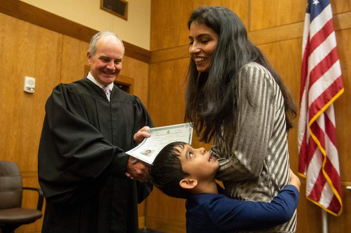 U.S. Judge Halil Ozerden presented naturalization documents to each new American citizen during a naturalization ceremony at Dan M. Russell Jr. Federal Courthouse in Gulfport on Friday, Oct. 7, 2022.