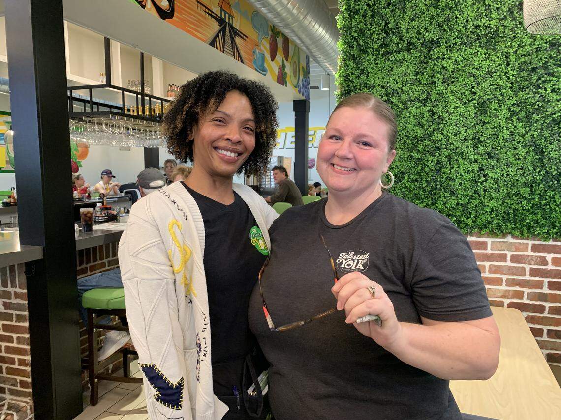 Melody Monroe, left, and Rebecca Curi are all smiles, even before counting the $3,600 tip they shared. The waitresses were presented the holiday tip at Toasted Yolk Cafe in Biloxi on Saturday, Jan. 3.