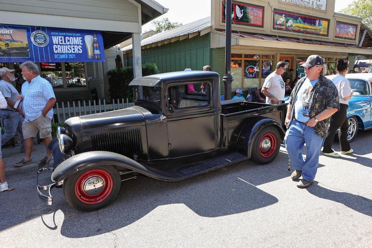 People admire all the old automobiles during the Ocean Springs Cruisin’ the Coast Block Party, October 8, 2021.