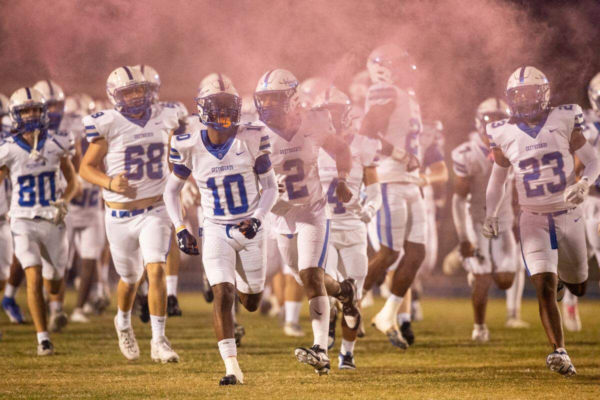 Ocean Springs players run onto the field before a game against Gulfport at Milner Stadium in Gulfport on Friday, Oct. 27, 2023. Ocean Springs beat Gulfport 30-7.