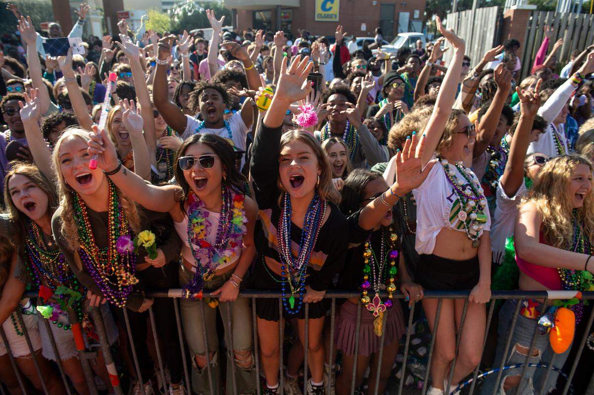 Paradegoers cheer for beads during the Gulf Coast Carnival Association Mardi Gras parade in Biloxi on Tuesday, Feb. 21, 2023. Fat Tuesday falls on Feb. 13 for 2024, when the GCCA parade will roll at 1 p.m. in Biloxi.