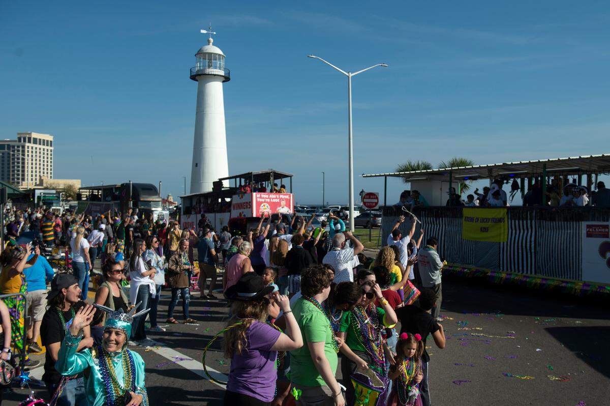 The Gulf Coast Carnival Association Mardi Gras parade passes the Biloxi Lighthouse on Highway 90 in Biloxi during Mardi Gras on Tuesday, Feb. 21, 2023.