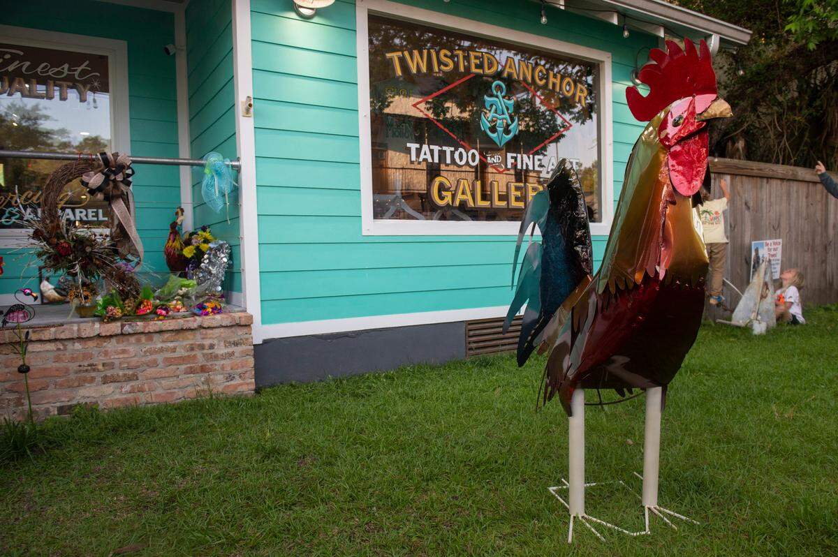 A statue of Carl the rooster stands outside Twisted Anchor Tattoo, a former stopping ground for the rooster, in Ocean Springs on Tuesday, May 10, 2022.