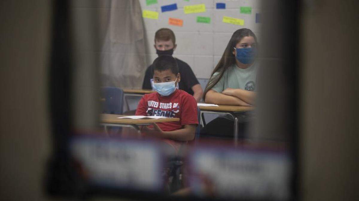 Students wear face masks as they sit in a classroom on the first day of school at Neshoba County Central Middle School, Wednesday, Aug. 5.