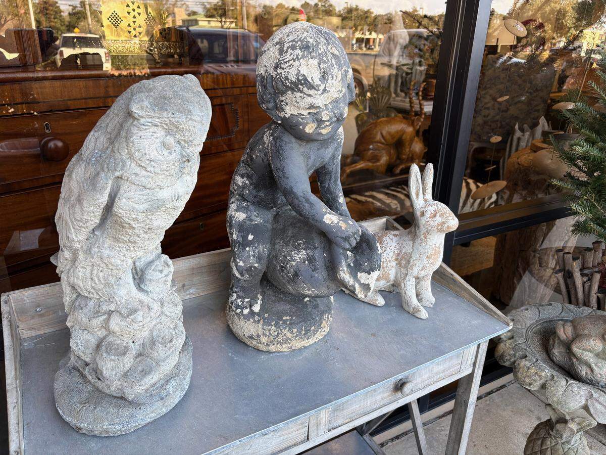 Statuettes sit on a table in front of OS Antiques in Ocean Springs.