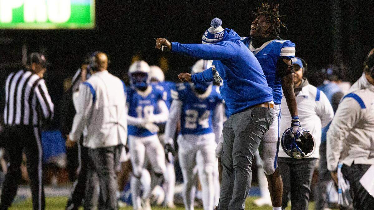 Ocean Springs’ players and coaches celebrate after a fumble leads to a touchdown for Ocean Springs over Oak Grove during a 6A playoff game at Greyhound Stadium in Ocean Springs on Friday, Nov. 18, 2022.