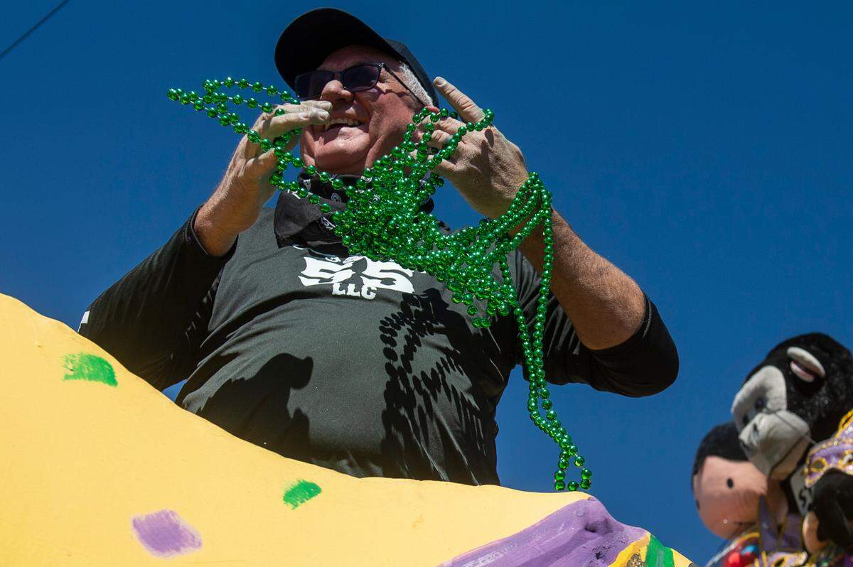A man on a float prepares to toss beads to the crowd during the Krewe of Nereids Mardi Gras parade on Highway 90 in Bay St. Louis on Sunday, Feb. 12, 2023.