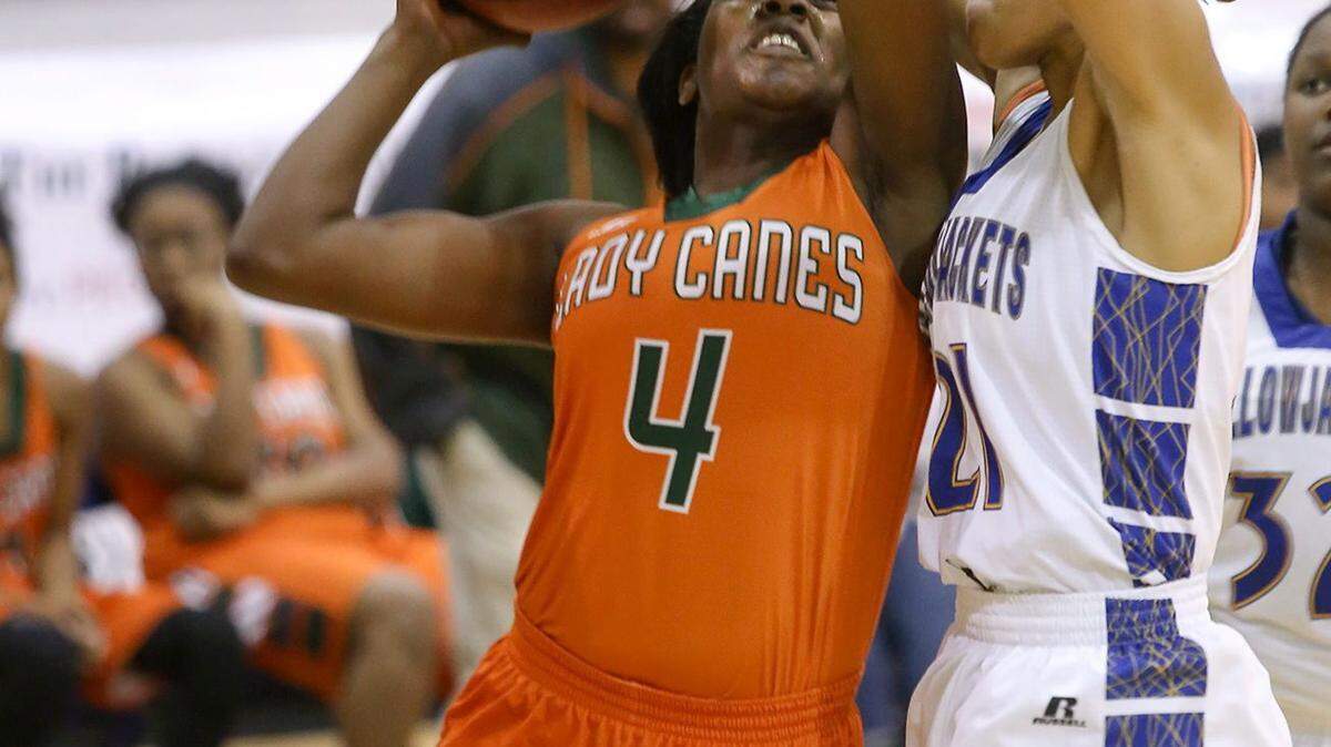 AMANDA McCOY/SUN HERALD 
 West Harrison's Ameshya Williams attempts a basket while guarded by St. Martin's Daphane White on Tuesday, December 8, 2015, at St. Martin High. St. Martin defeated West Harrison, 64-41.