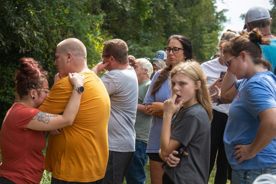 The family members of Baleigh Bowlin and Chloe Taylor gather around a memorial for the girls at the site of a fatal car accident that claimed the lives of both girls off of Highway 613 in Hurley on Monday, Oct. 17, 2022.