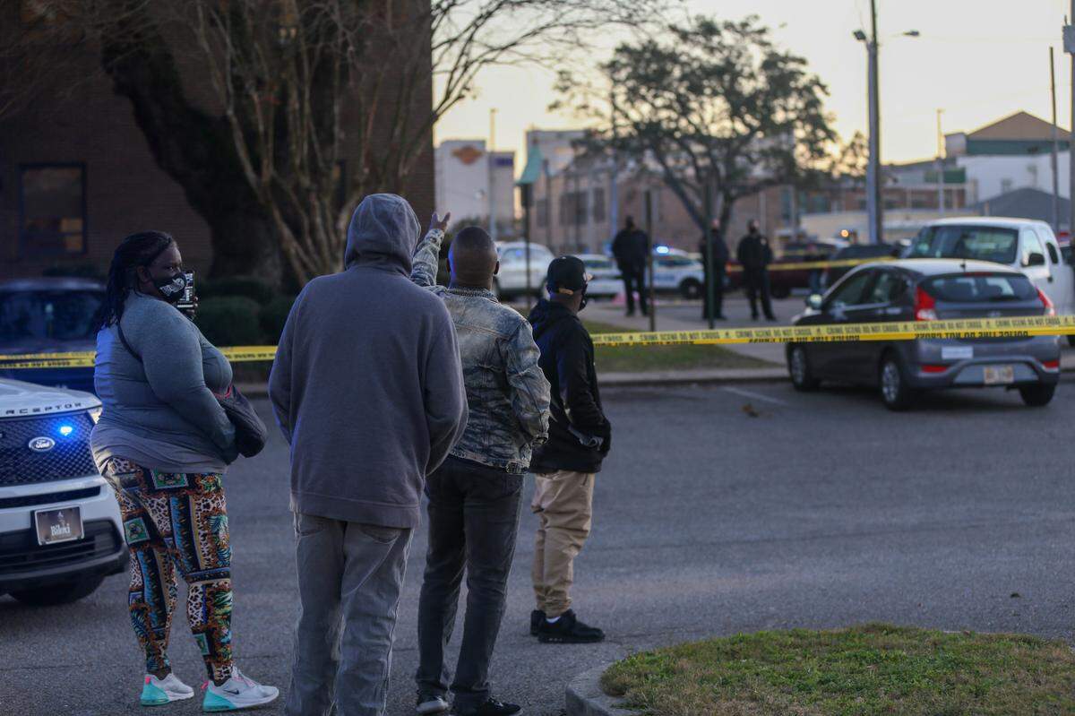 People gather at the scene of a shooting at the Harrison County courthouse in Biloxi on Friday, Jan. 15, 2021.