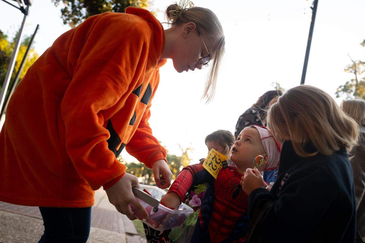 Eli Hillner accepts candy during Boo On The Rue in Biloxi on Thursday, October 30, 2025.